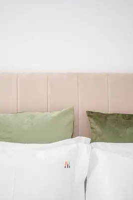 two white beds with green pillows in a bedroom at Liiiving in Porto - Modern & Glam Apartment J in Porto