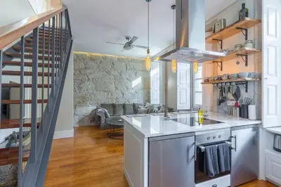 a kitchen with a sink and a stove at Stylish Downtown Porto Duplex 2BR Walk everywhere! in Porto