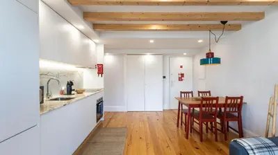 a kitchen and dining room with a table and chairs at Stylish Duplex with Balcony in Porto by LovelyStay in Porto
