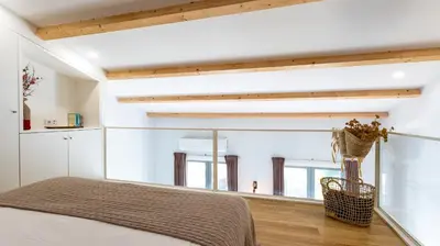 a bedroom with a bed and a large window at Stylish Duplex with Balcony in Porto by LovelyStay in Porto