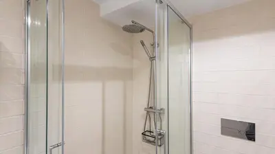 a shower with a glass door in a bathroom at Stylish Duplex with Balcony in Porto by LovelyStay in Porto
