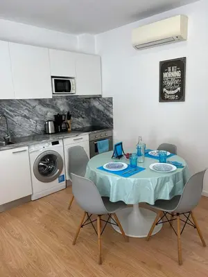 a kitchen with a table and chairs in a kitchen at Bonfim - Porto River in Porto