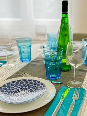 a table with plates and glasses and a bottle of wine at Bonfim - Porto River in Porto