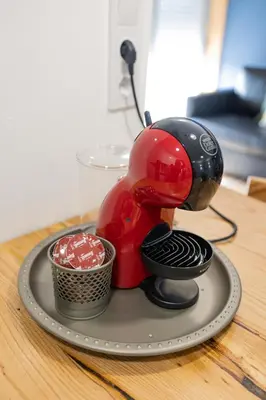 a red and black appliance sitting on a tray at Porto Cathedral III in Porto