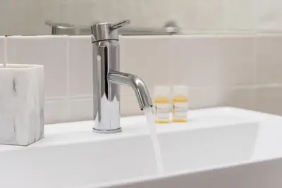 a sink with a faucet with water coming out of it at GuestReady - Rose Apartment in Porto