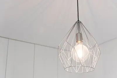 a glass hanging light hanging from a ceiling at GuestReady - Rose Apartment in Porto