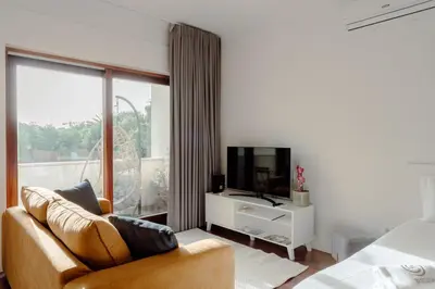 a living room with a couch and a television at Almada 516 by Best2Stay in Porto