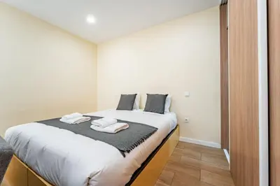 two pillows with the wordournost on them on a bed at Close to Everything Your Oporto Gray PRM 2T in Porto