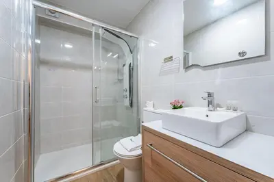a bedroom with a bed with two towels on it at Close to Everything Your Oporto Gray PRM 2T in Porto