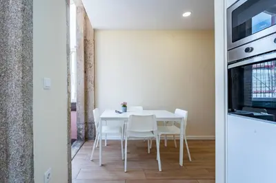 a living room with a couch and a tv on a wall at Close to Everything Your Oporto Gray PRM 2T in Porto