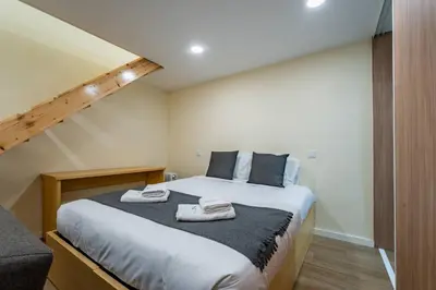 a white table and chairs in a room with a red door at Close to Everything Your Oporto Terrace PRM 1T in Porto