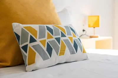 a pillow sitting on top of a bed at GuestReady – The Mythic Apartments in Porto