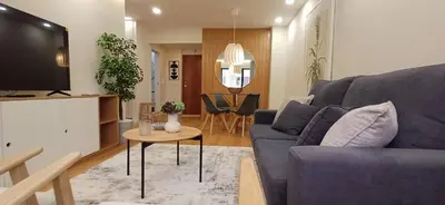 a living room with a blue couch and a tv at Barramares Concept Lifestyle Oporto City Center in Porto