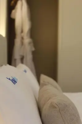 a close up of a persons leg on a bed at Barramares Concept Lifestyle Oporto City Center in Porto
