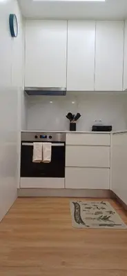 a kitchen with a stove and white cabinets and a rug at Barramares Concept Lifestyle Oporto City Center in Porto