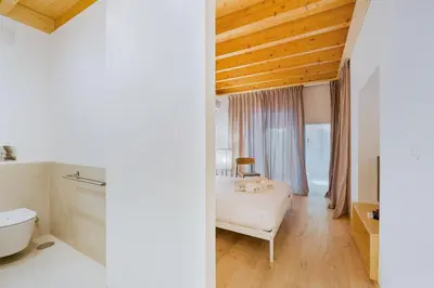 a bedroom with a bed and a bathroom with a tub at GuestReady - Cedofeita Collection Apartments in Porto