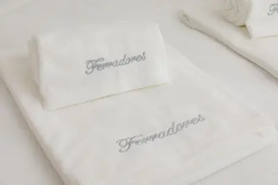 a pair of towels with the wordfemininators on them at Clérigos Apartments Porto - Ferradores in Porto