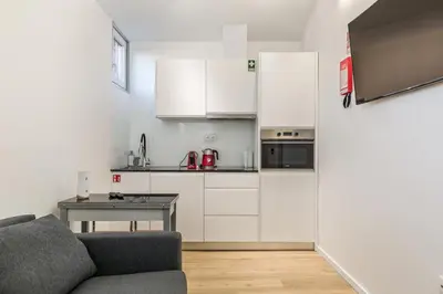 a kitchen with a couch and a table in a room at Clérigos Apartments Porto - Ferradores in Porto