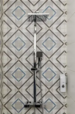 a bathroom with a tile wall with a shower at Clérigos Apartments Porto - Ferradores in Porto