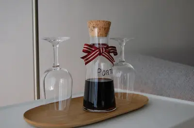 a bottle with a cork and two wine glasses at Penthouse Inn Bolhão in Porto