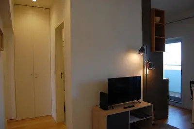 a living room with a television on a wooden table at Penthouse Inn Bolhão in Porto