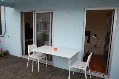 a white table and chairs in a room at Penthouse Inn Bolhão in Porto
