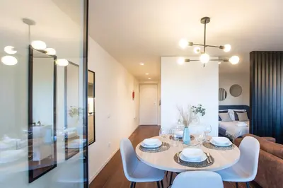 a dining room and living room with a table and chairs at Porto Gallery District Escape, Central Retreat in Porto