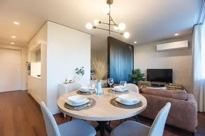 a dining room and living room with a table and chairs at Porto Gallery District Escape, Central Retreat in Porto