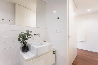 a white bathroom with a sink and a mirror at Porto Gallery District Escape, Central Retreat in Porto
