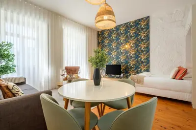 a living room with a table and chairs at Historic Porto Nook Downtown Porto near metro in Porto