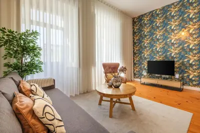 a living room with a couch and a tv at Historic Porto Nook Downtown Porto near metro in Porto