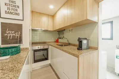 a kitchen with a stainless steel refrigerator and a counter at City Center Comfort Apartment by Vacationy in Porto