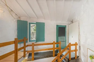 a room with green shutters and a wooden bench at GuestReady - A special place in Porto in Porto