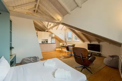 a bedroom with a bed and a living room at GuestReady - A Porto Nest with a Twist in Porto