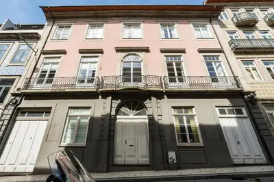 a large pink building with white doors and windows at GuestReady - A Porto Nest with a Twist in Porto