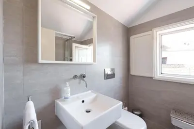 a bathroom with a white sink and a mirror at VIVA Loft in Historic Center Porto in Porto