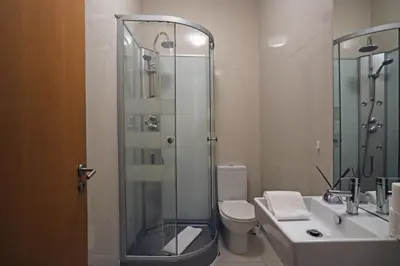 a bathroom with a shower and a toilet and a sink at Spot Apartments Sao Bento in Porto