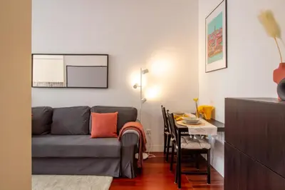 a living room with a couch and a table at Santa Teresa Studio by LovelyStay in Porto