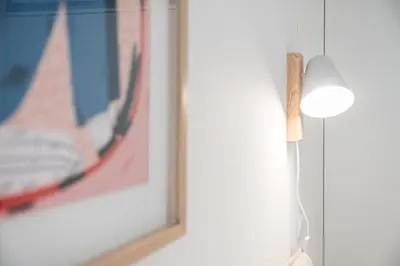 a white lamp next to a picture on a wall at GuestReady - Clérigos Tiles House in Porto
