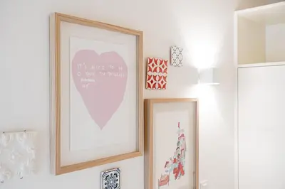 a couple of framed pictures on a wall in a room at GuestReady - Clérigos Tiles House in Porto