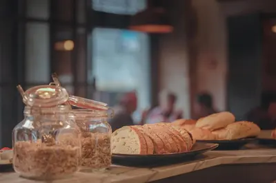a table topped with bread and a jar of nuts at My Ribeira Guest House in Porto