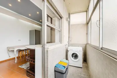 a laundry room with a washing machine and a table at GuestReady - Peaceful retreat near Casa da Música in Porto