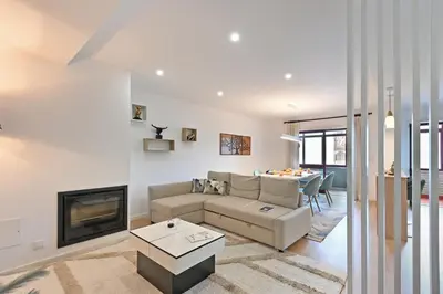 a living room with a couch and a fireplace at White Stripes House of Music in Porto