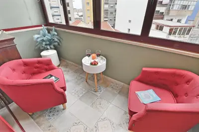 two red chairs and a table in a room at White Stripes House of Music in Porto