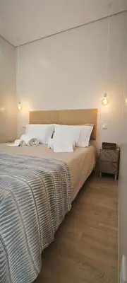 a bedroom with a large bed with white pillows at Apartamento D'Alegria in Porto