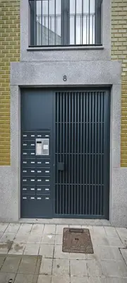 a blue garage door on the side of a building at Apartamento D'Alegria in Porto