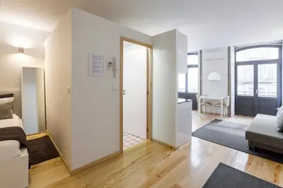 a room with a bed and a living room at BO - Almada in Porto