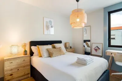 a bedroom with a large white bed with a window at GuestReady - Lovely home in Campanhã in Porto