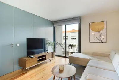 a living room with a couch and a tv at GuestReady - Lovely home in Campanhã in Porto