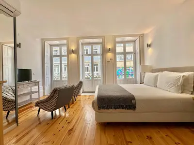 a bedroom with a bed and a desk and chairs at YOUROPO - Capela in Porto
